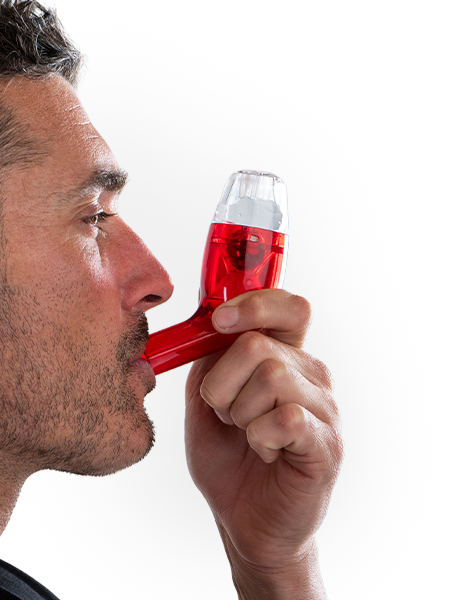 Man using a red and white breathing device on a white background