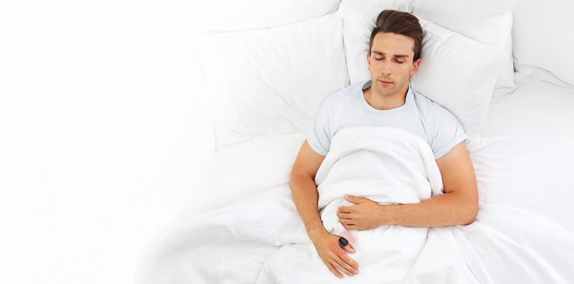 Man lying in bed with a white pillow and blanket using O2Ring